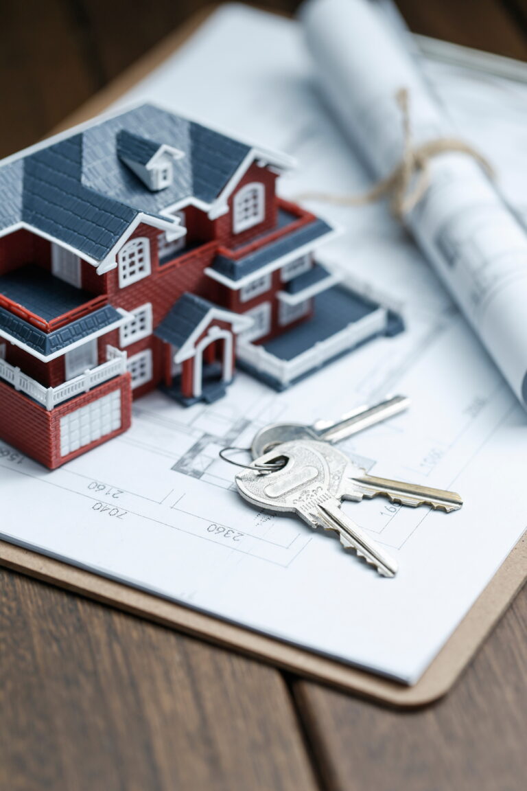 villa house model, key and drawing on retro desktop (real estate sale concept)
